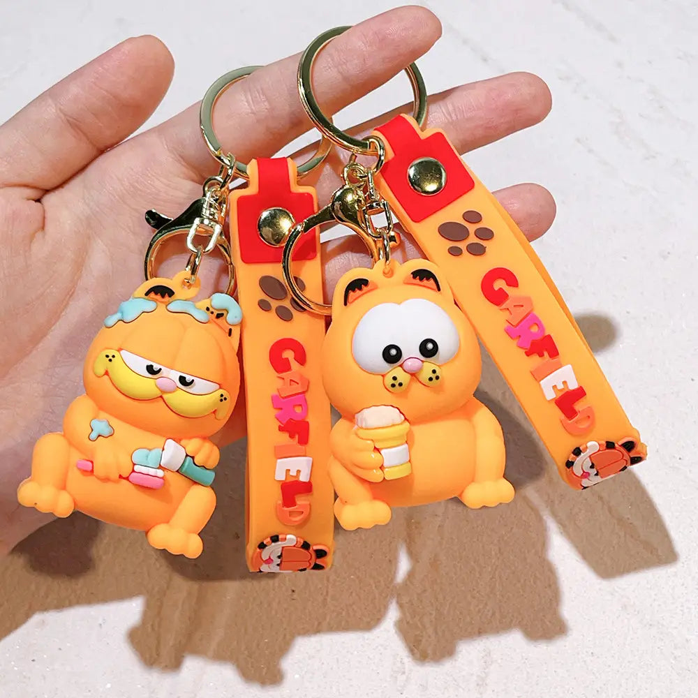 Orange Garfield keychains made of rubber featuring red straps and gold-tone hardware as anime cat key pendants.