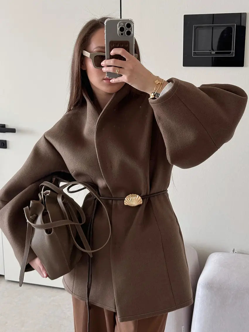 Brown wool belted coat with wide puffed sleeves and a shell-shaped gold buckle for winter wear.