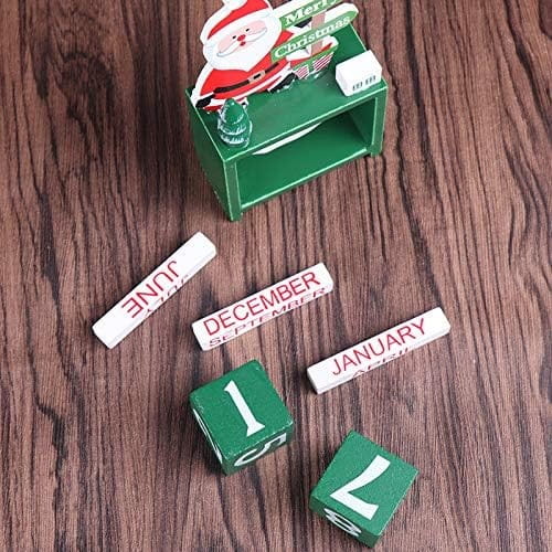 Green wooden Christmas countdown calendar blocks featuring a Santa Claus figure on top for festive holiday decoration.