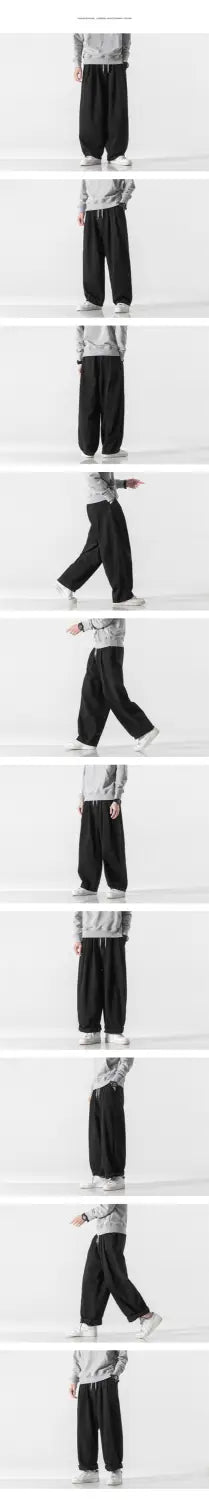 Pantalons en jean noir à jambes larges au style hip hop ample, présentant une silhouette décontractée et des poignets élastiques.