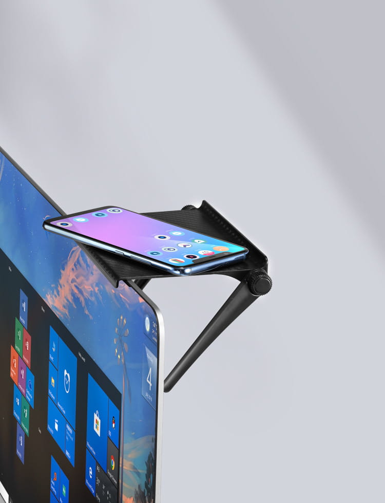 black adjustable phone stand made of durable material holding a smartphone on top of a monitor as part of an adjustable screen top storage shelf monitor stand.