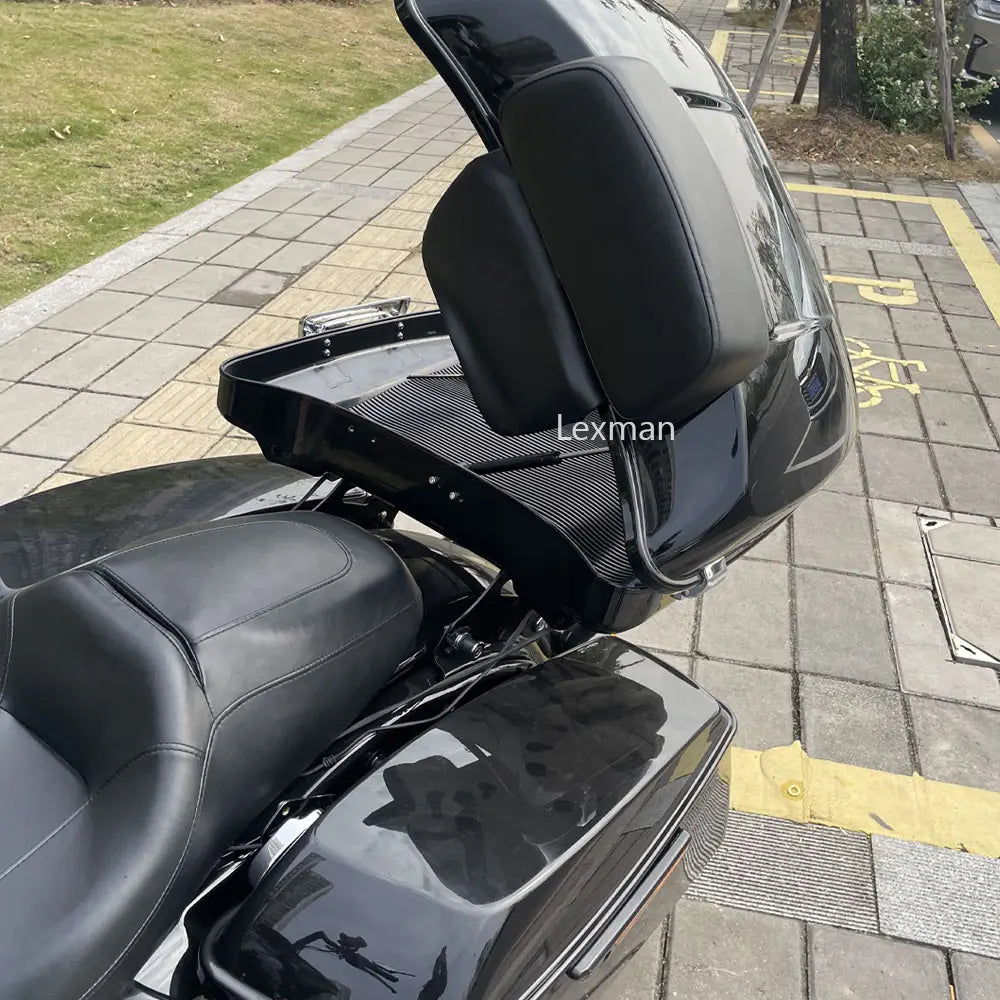 Black glossy motorcycle saddlebag with carbon fiber textured interior and padded black leather seat shown from the back for Harley touring trunk support rod 2014-2023.