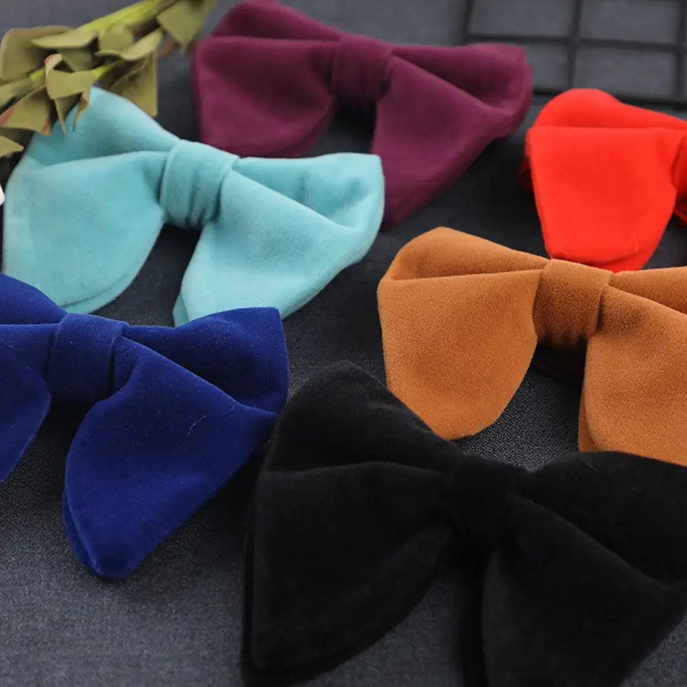 A collection of velvet bow ties in assorted vibrant colors including teal maroon orange navy blue and black for formal neckwear gift.