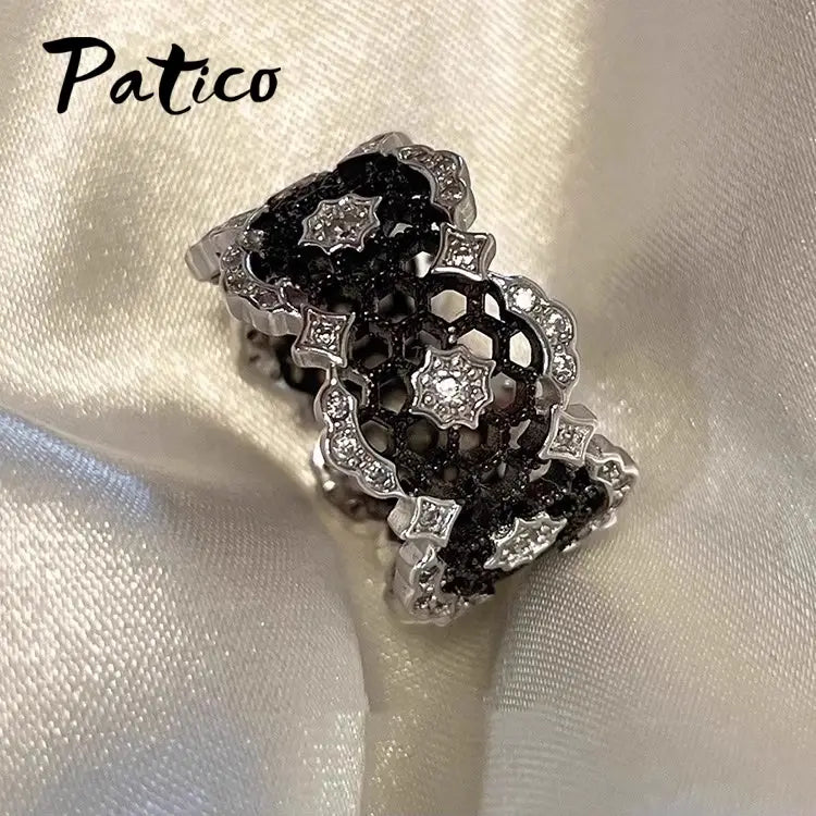Patico sterling silver black geometric ring for women featuring an intricate honeycomb pattern with sparkling clear stones.