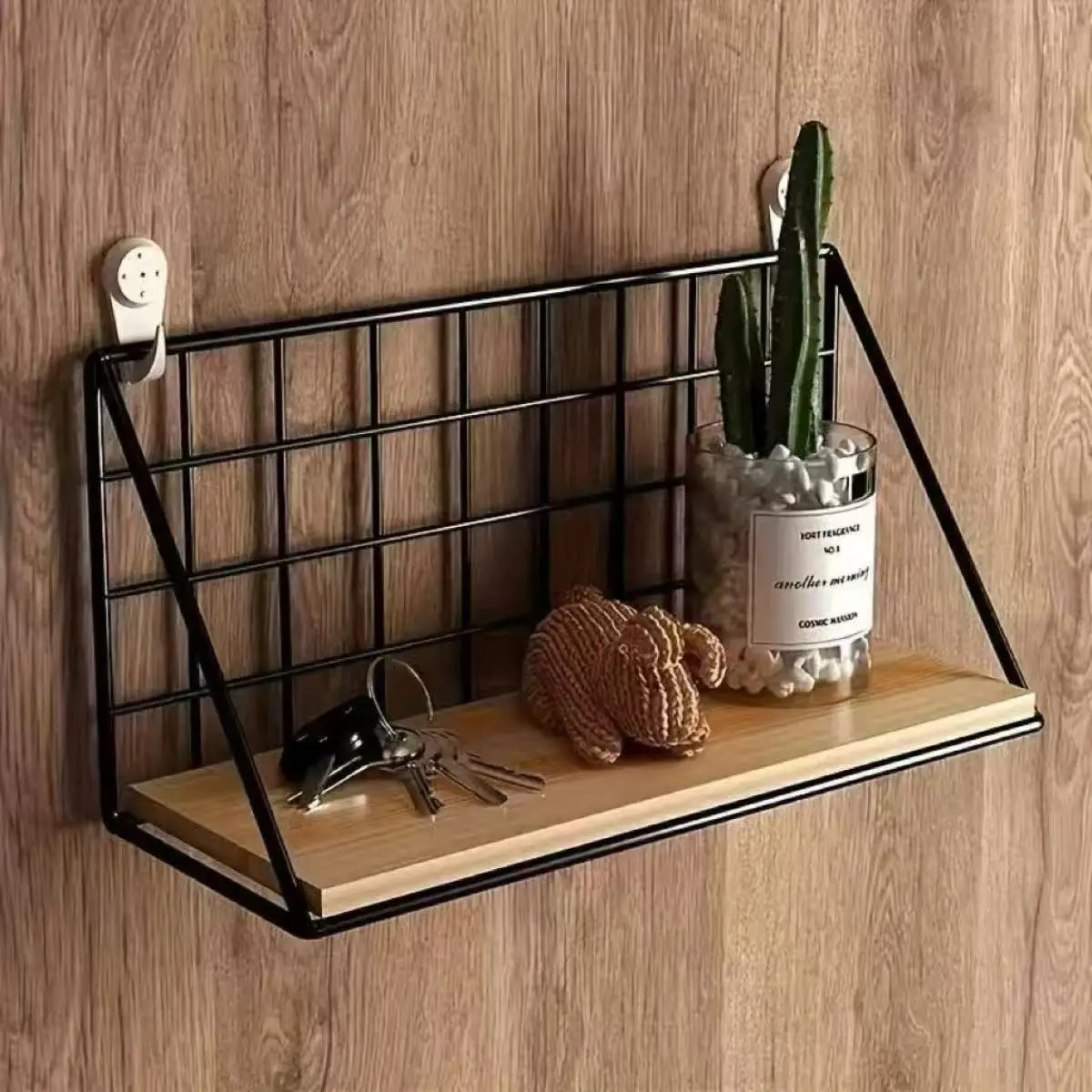 Black metal grid wood wall shelf with a light wood plank base and wire basket storage.
