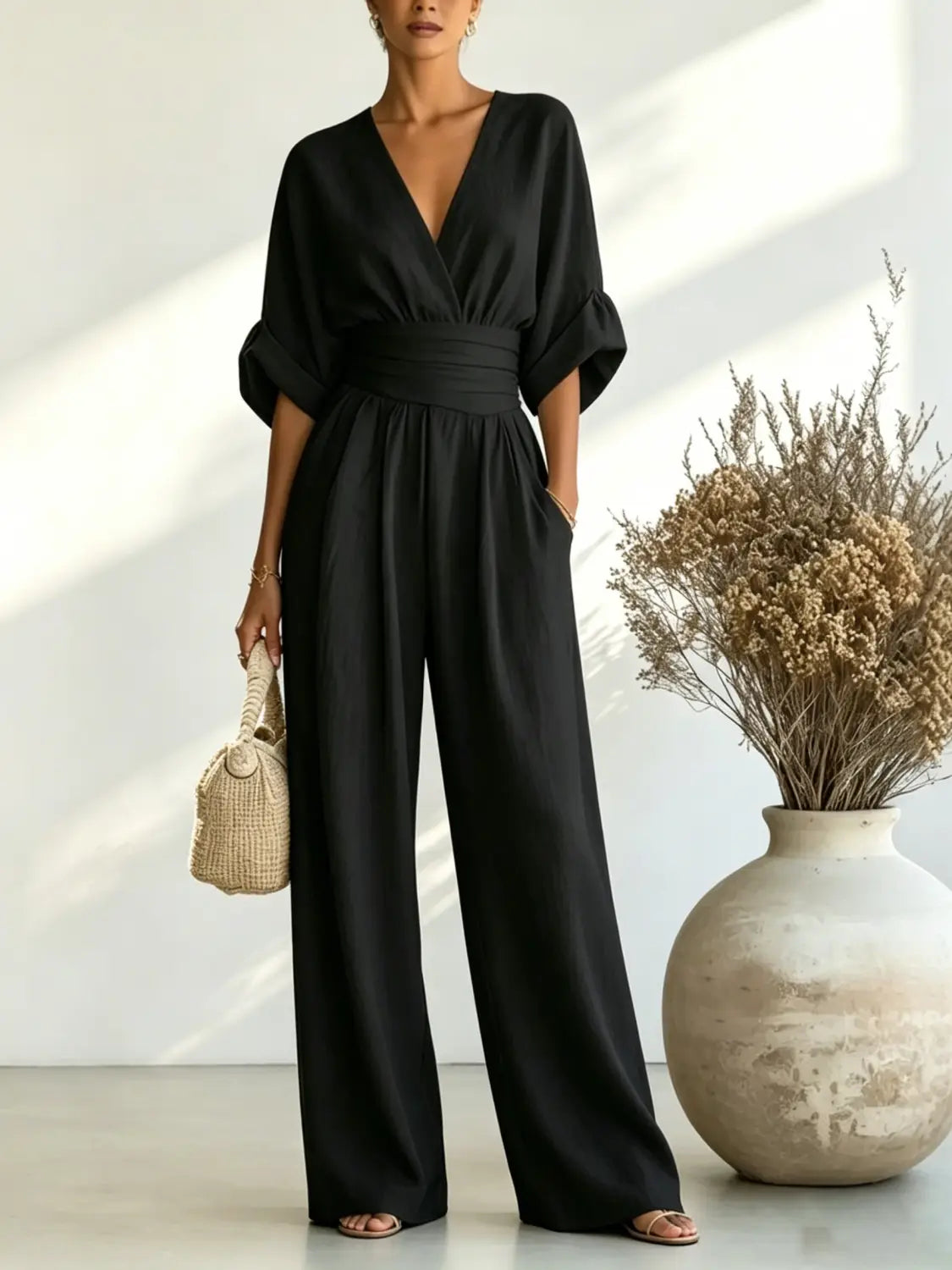 black satin v-neck wide-leg jumpsuit with cinched waistband and three-quarter puff sleeves