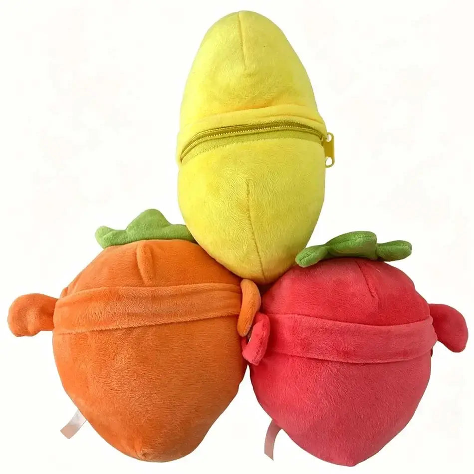 Three plush fruit coin purses in yellow orange and red with green leafy tops made of soft stuffed animal material for storing coins.