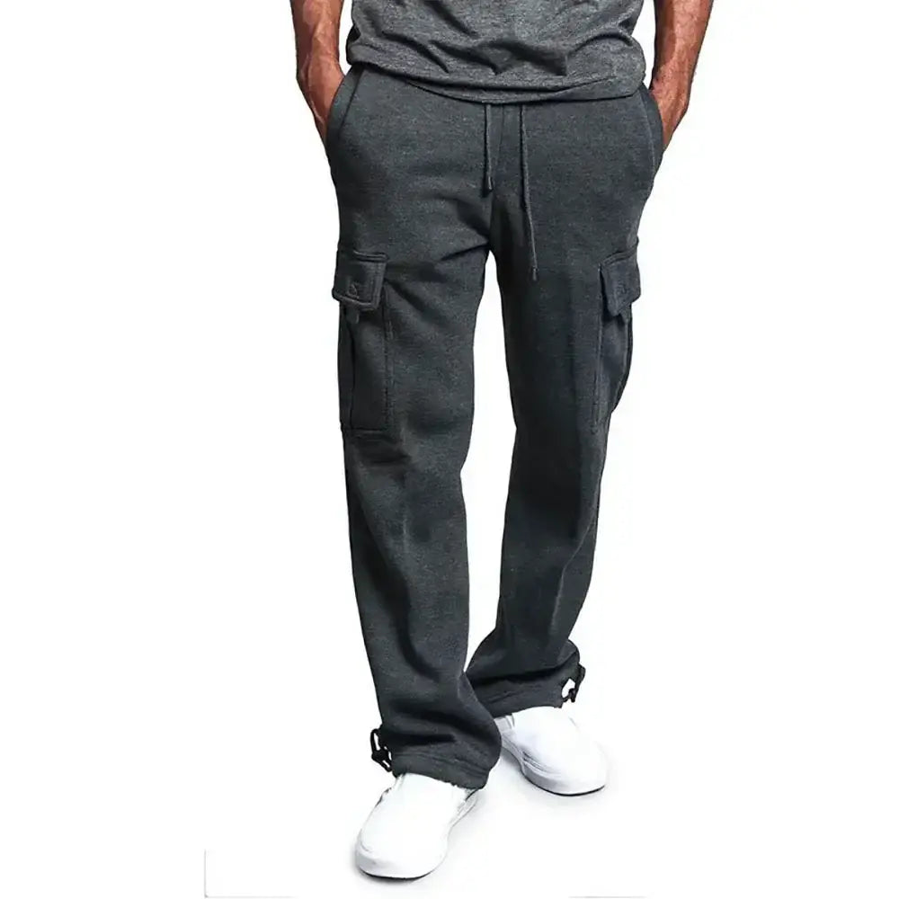 Pantalons cargo pour homme de couleur gris foncé à coupe ample de style jogging, avec des poches latérales et une ceinture à cordon de serrage.