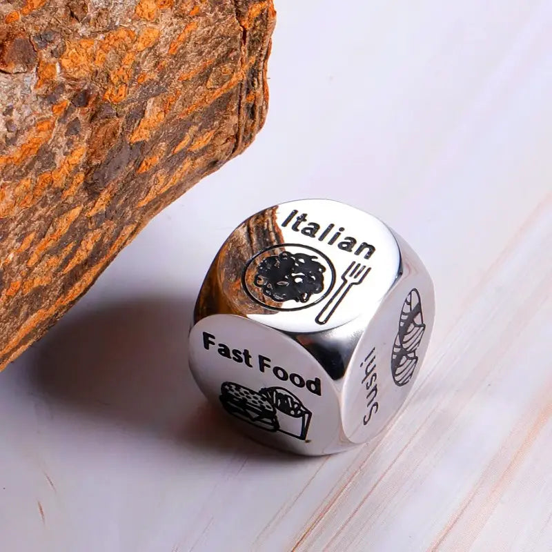 Silver metallic stainless steel food decision dice for couples date night with engraved faces featuring italian and fast food options.