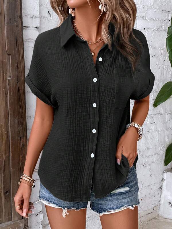 Black textured women cotton short sleeve button up shirt with rolled cuffs and a collar.