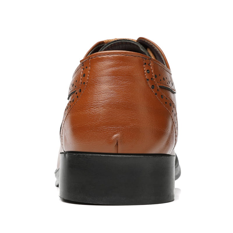 Men’s leather brogue dress shoe featuring brown leather with decorative perforations and a black sole.