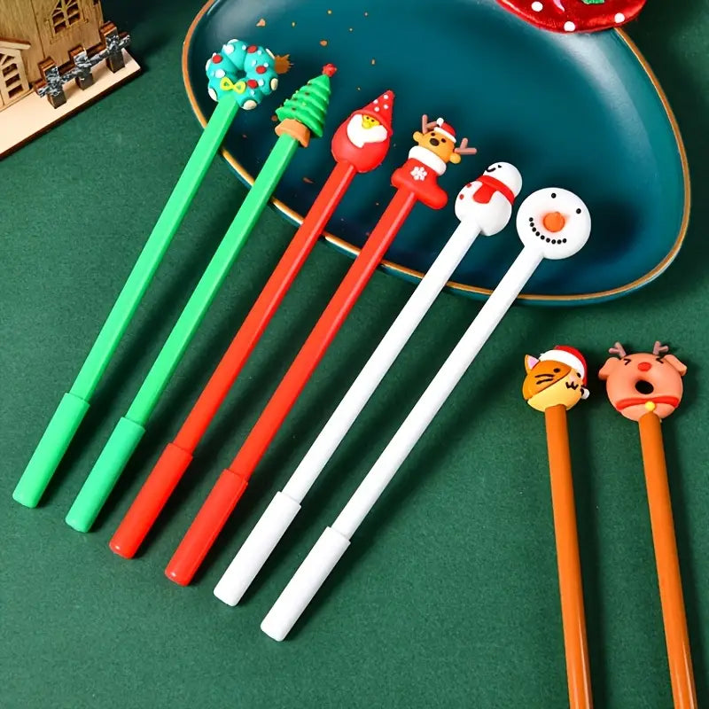 A set of colorful Christmas gel pens with plastic holiday character tops featuring Santa, snowman, reindeer, and tree designs for festive holiday stationery use.