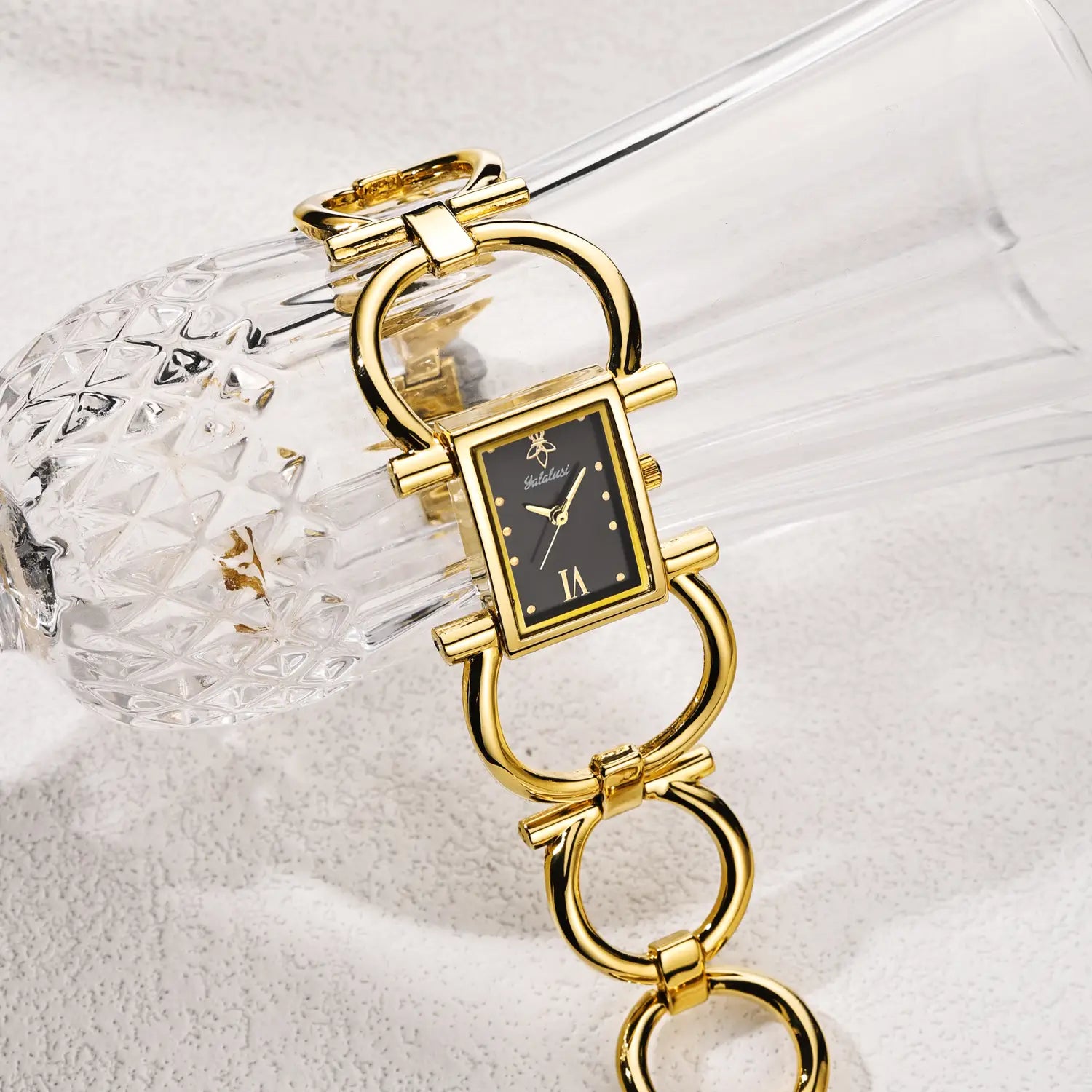 Gold luxury quartz women watch bracelet with gold-toned rectangular case, black dial, roman numeral hour markers, and distinctive chain-link bracelet design.