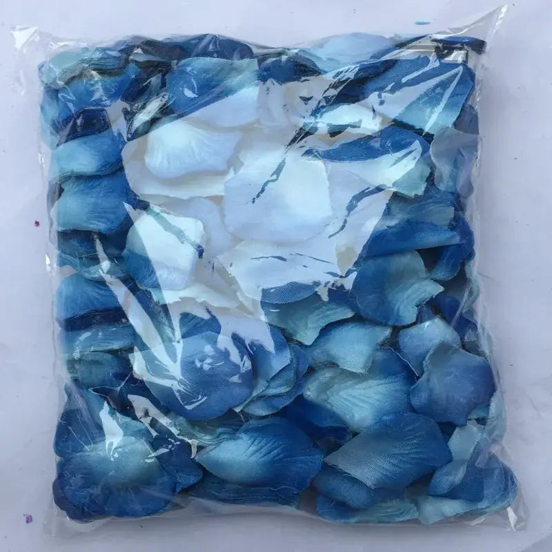 A clear plastic bag containing 5500 colorful artificial rose petals in shades of blue and white for wedding decor.