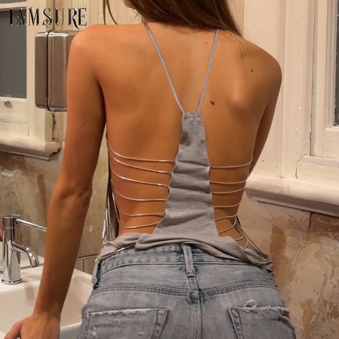 Gray open back knit camisole top featuring thin metallic straps and horizontal cutouts, ideal for drop shipping with extended protection time for purchase protection.
