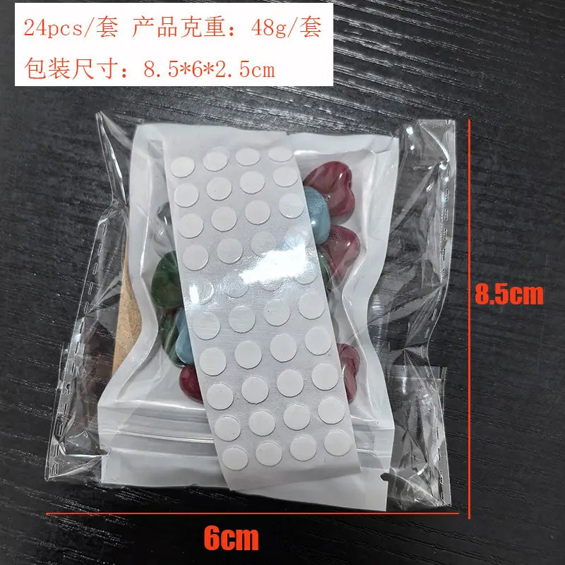 a sheet of white circular adhesive dots packaged with assorted colorful heart-shaped decorative stones for gemstone heart valentine cards 24 pack