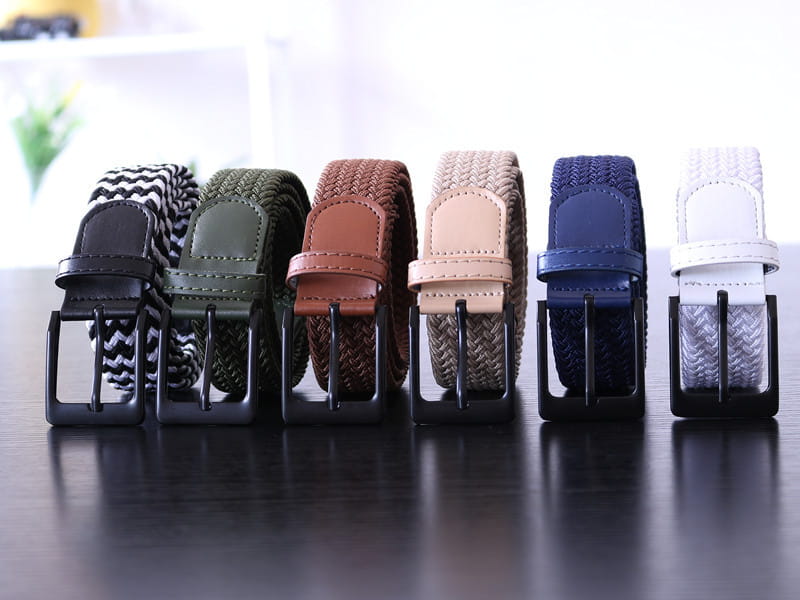 Ceinture tactique élastique en toile pour homme, boucle à épingle présentée en cinq options de couleurs tissées : noir, olive, vert, brun, beige et bleu marine, avec des boucles assorties aspect cuir.