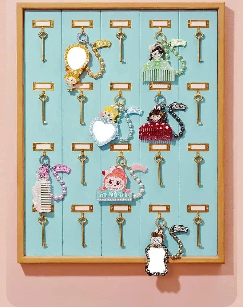 Eine Kollektion bunter Schlüsselanhänger-Zubehörteile mit Cartoon-Motiven, die Figuren und dekorative Elemente wie Spiegel, Kämme und Herzen aus der Pop-Mart-Labuub-the-Monsters-Hair-Salon-Guess-Bag umfassen