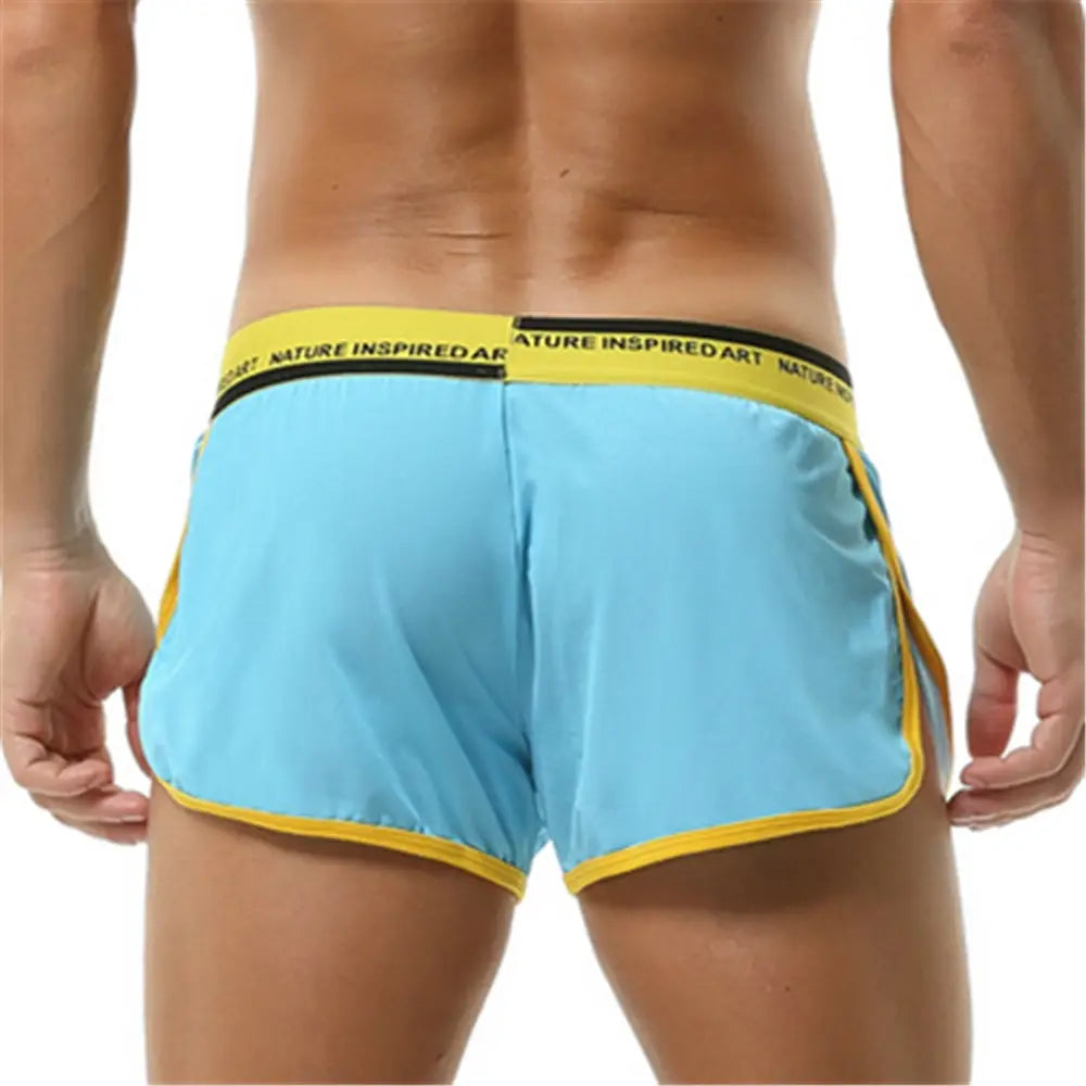 Boxer briefs para hombre transpirables, atléticos y de dormir, de color azul claro, con ribete amarillo y una pretina que presenta un texto con arte inspirado en la naturaleza.