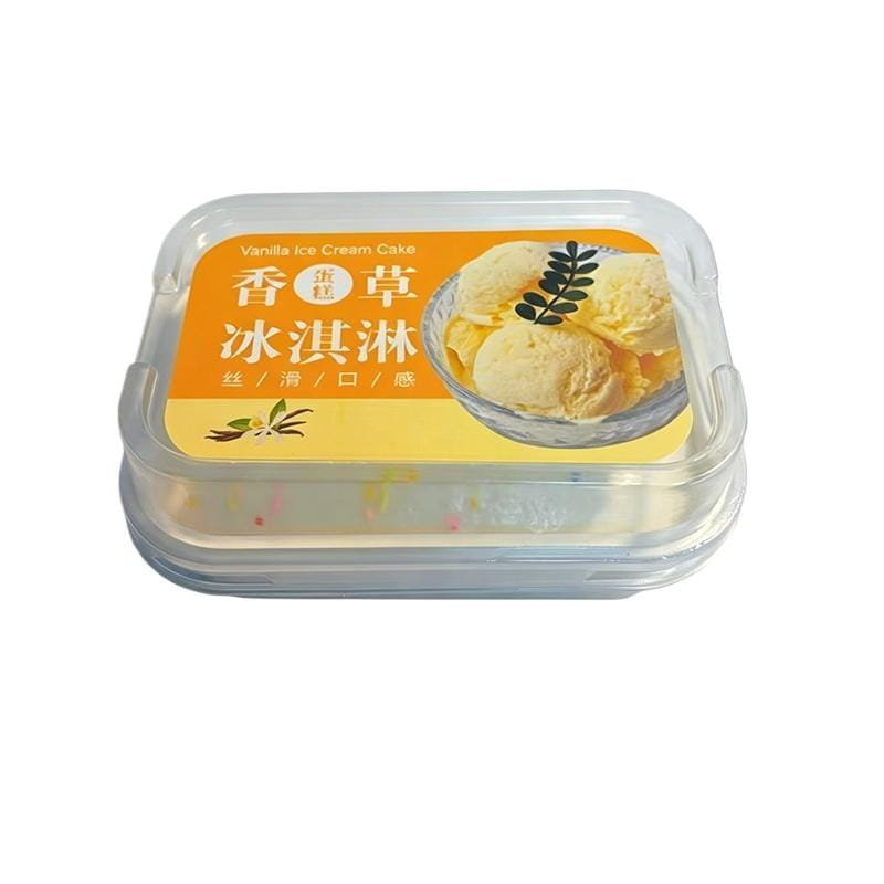 juguete sensorial tipo fidget de pastel simulado de helado de crecimiento lento, diseñado como un pastel de helado de vainilla, en un recipiente de plástico transparente con una etiqueta naranja que presenta porciones e ilustraciones de vaina de vainilla.