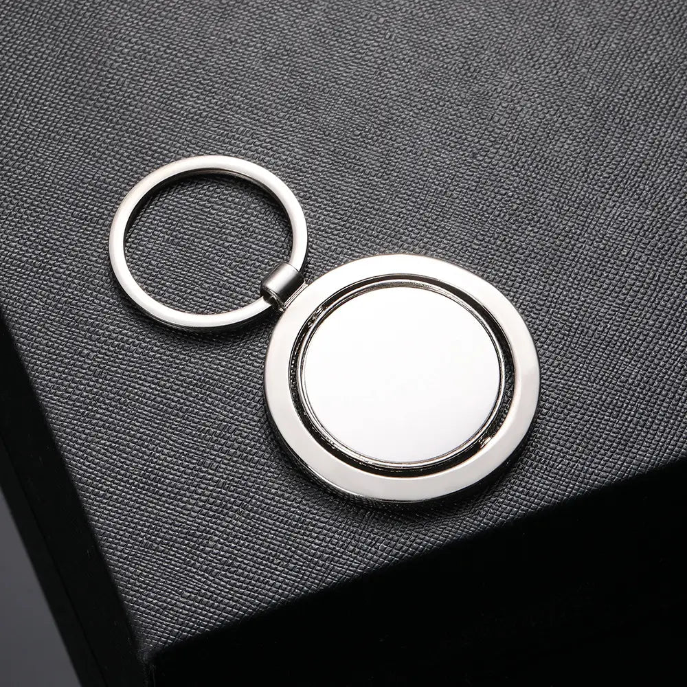 Silver metallic rotating circle keychain featuring a circular rotating disc design ideal as a gift accessory.