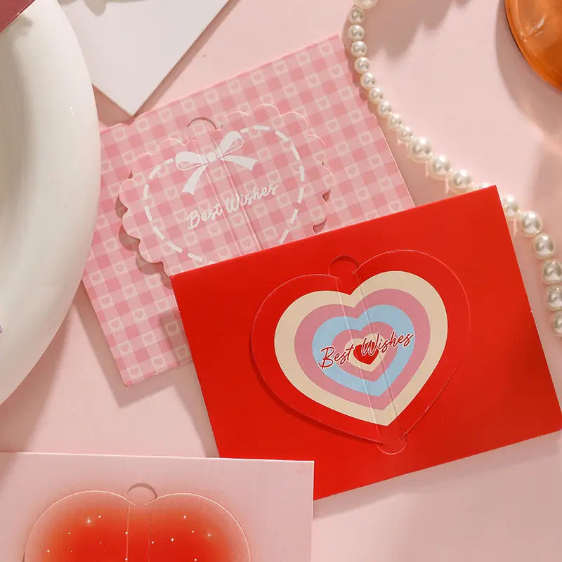 Red heart-shaped 3d greeting card with layered pastel concentric hearts and best wishes text for Valentine wedding notes.
