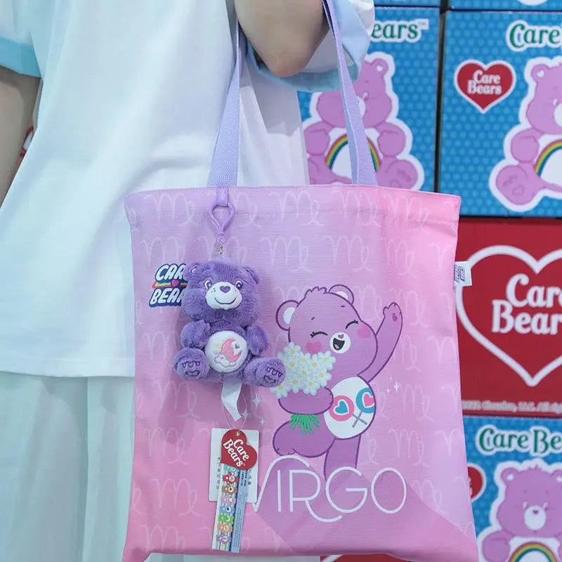 Pink care bears plush bag pendant keychain toy featuring a tote bag with virgo printed in white and a purple plush bear charm.