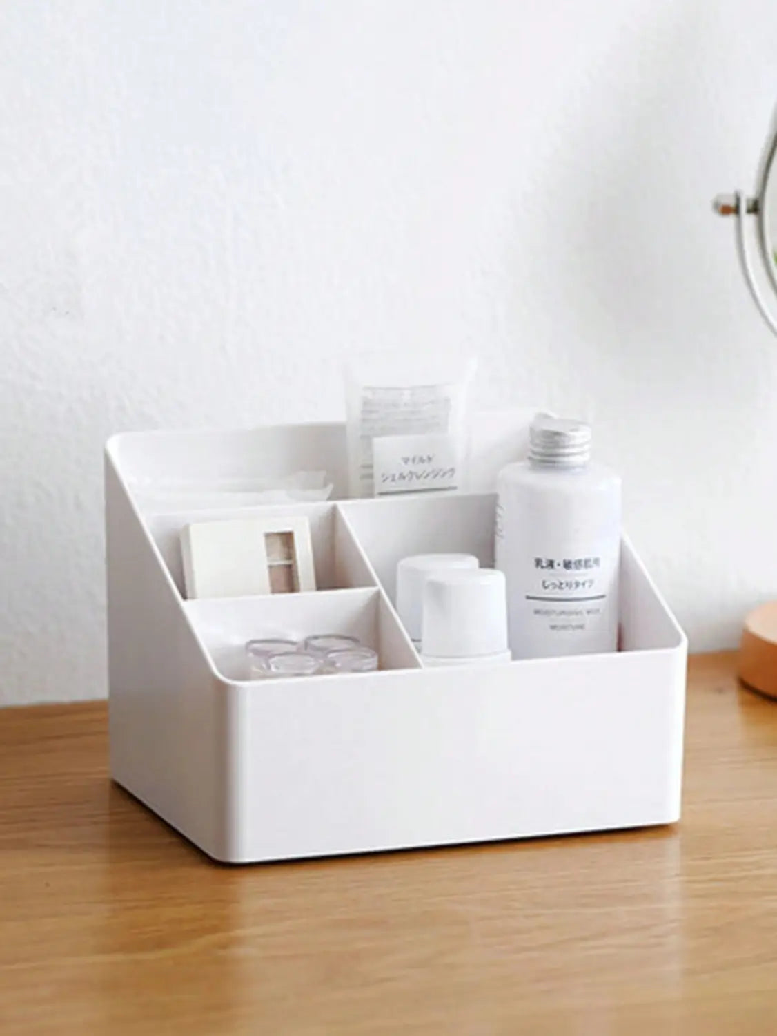 White plastic desk organizer and remote holder with multi-compartment design and clean minimalist style.