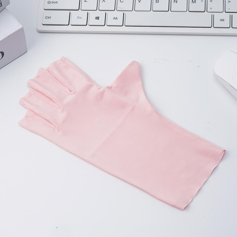 A delicate pink satin fingerless driving glove with uv protection and a smooth glossy finish.