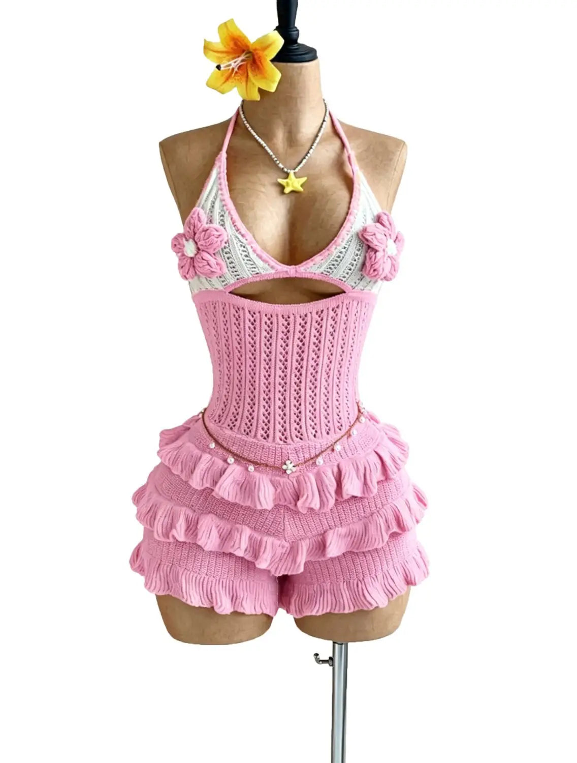 pink knitted ruffle halter romper summer playsuit featuring a halter top with floral embellishments and matching ruffled shorts