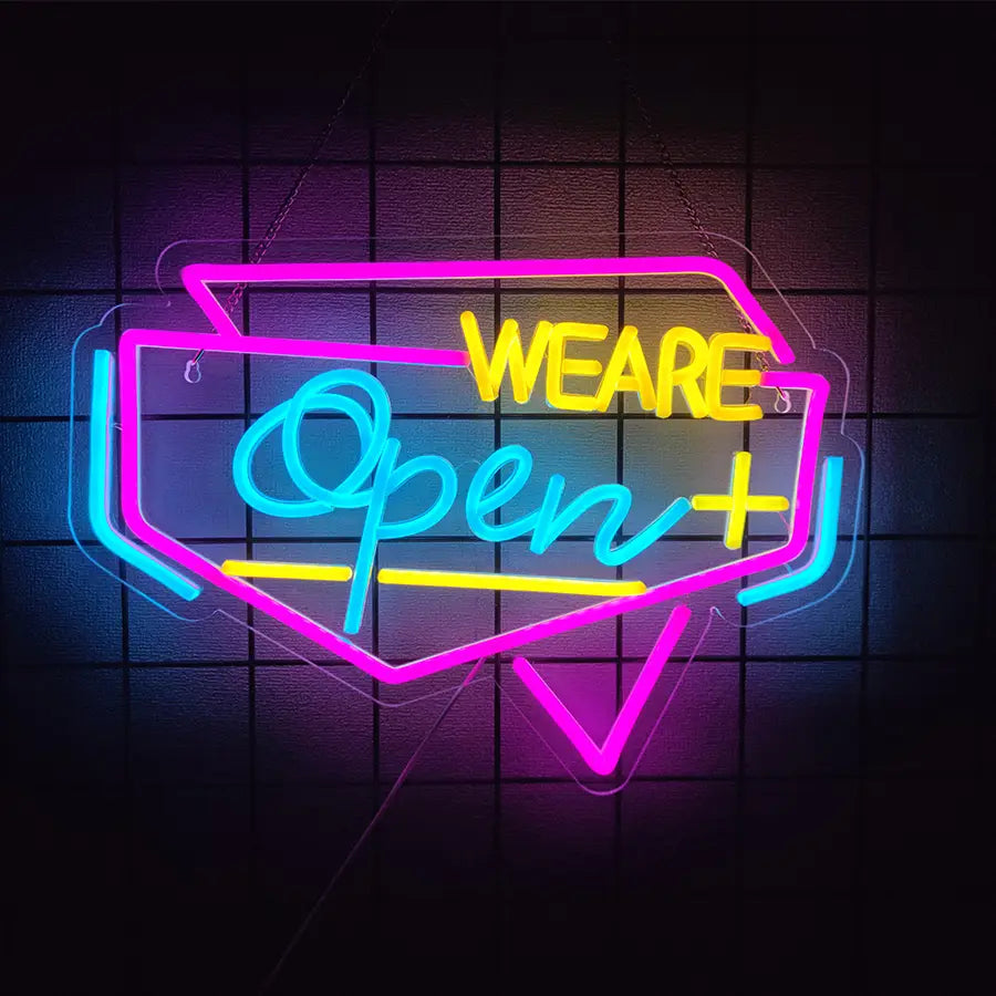 Enseigne au néon à LED vibrante, décoration murale alimentée par USB, avec un tube lumineux rose, bleu et jaune formant les mots « Nous sommes ouverts » dans un style rétro en forme de bulle de dialogue.
