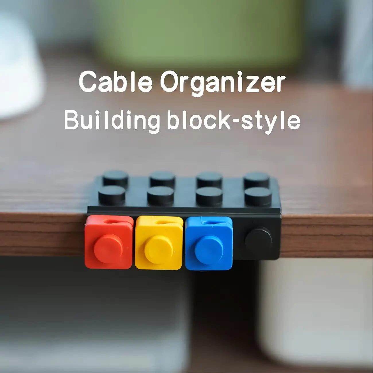Black plastic modular brick cable organizer with red yellow and blue building block-style connectors in two sets.