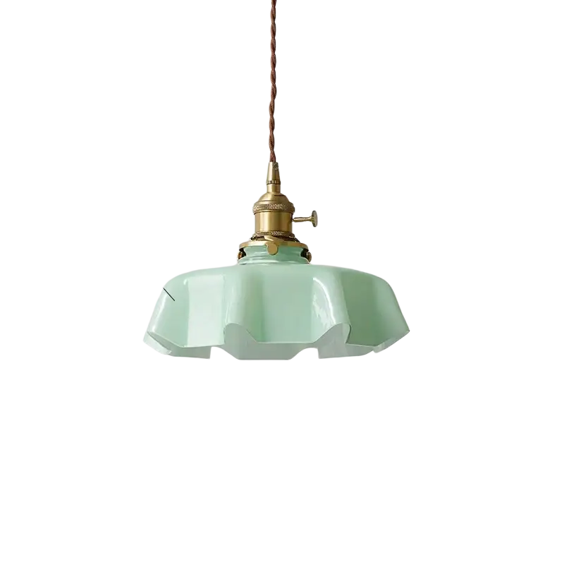 Light green glass flower skirt pendant lamp with brass fixture and adjustable cord shown from front angle