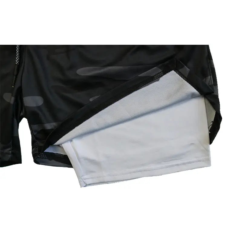 men 2 in 1 gym shorts featuring black mesh fabric with a reflective silver lining designed for quick dry workout activewear.
