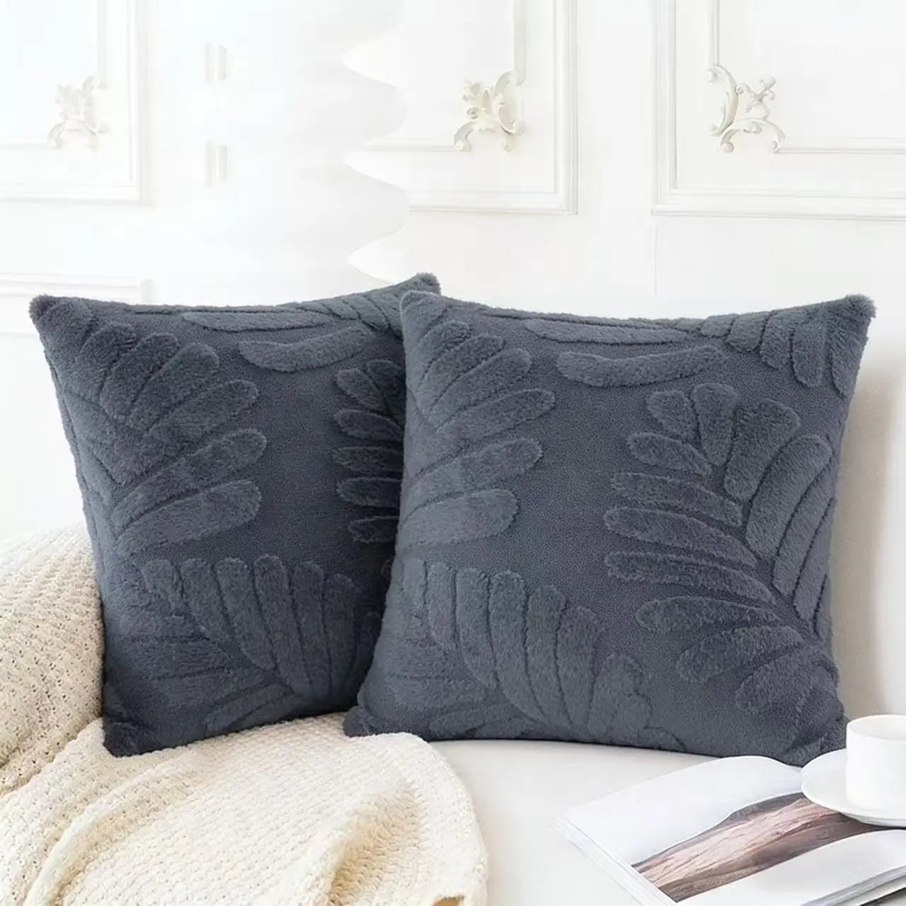 Dark gray plush throw pillow covers with raised leaf embroidery in soft material for decorative use.
