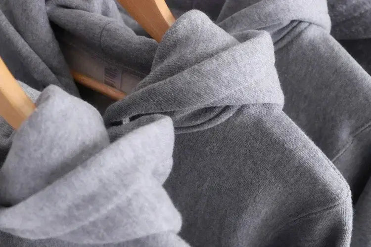 Gray oversized v back graphic hoodie with soft textured fabric and ribbed cuffs designed for streetwear pullover use.