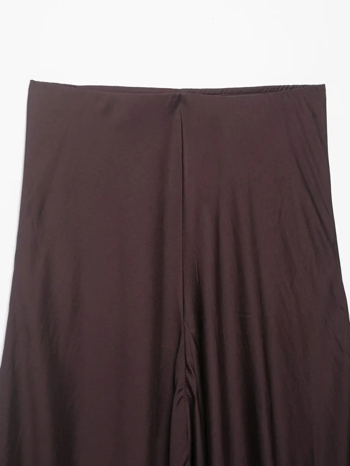 Ein eleganter dunkelbrauner Satin-Plisseerock im Midi-Format mit hoher Taille und einer dezenten vertikalen Naht in der Mitte.