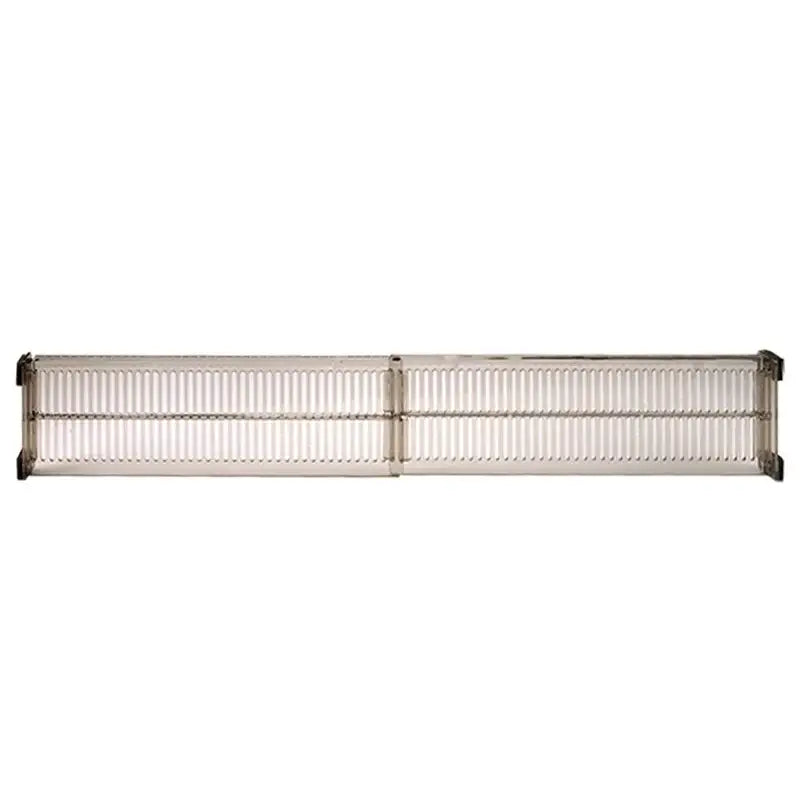 silver metallic industrial-style ventilation grille with ribbed grid design on the back side of a drawer partition adjustable plastic storage divider
