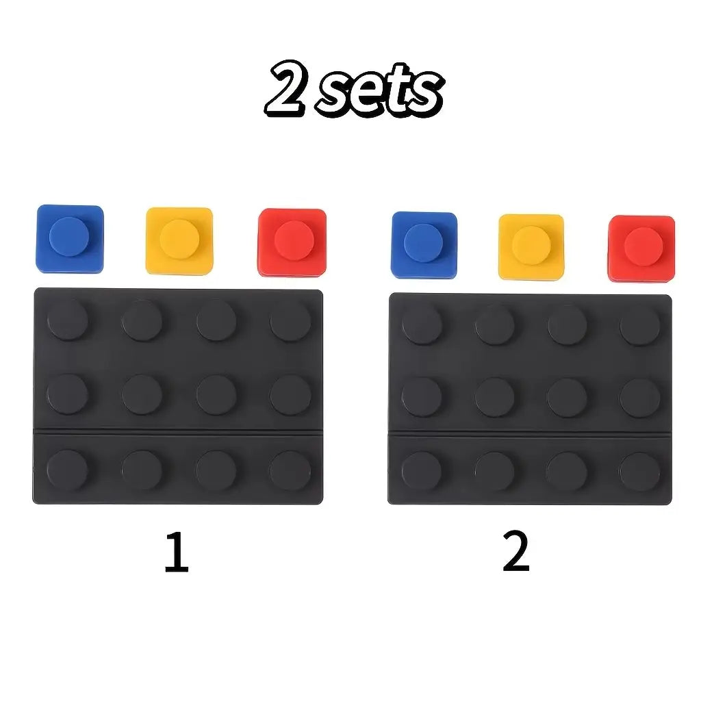 black silicone lego brick-shaped adhesive pads with blue yellow and red circular caps for modular brick cable organizer 2 sets.