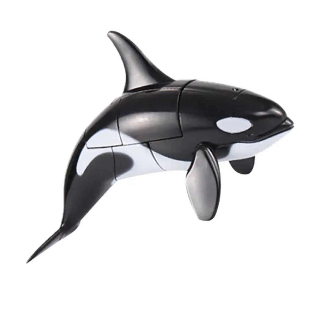 Black and white plastic orca toy with a sleek glossy finish as part of shark transforming robot toy finished goods.
