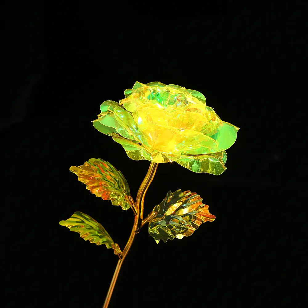 A glowing yellow and green crystal rose with a gold-toned stem and leaves from the gold foil artificial rose eternal gift flower collection.