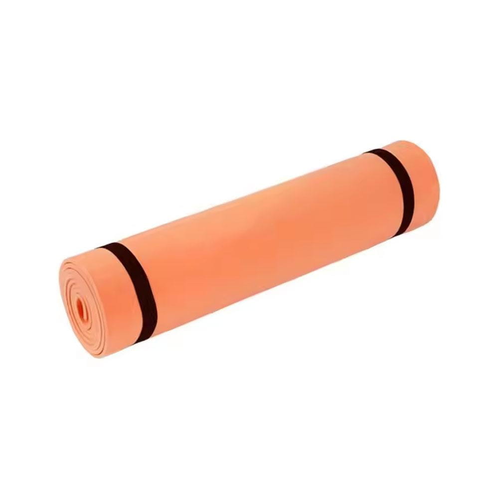 a rolled-up peach-colored yoga mat made of eva material secured with two black elastic bands for portable non-slip fitness use