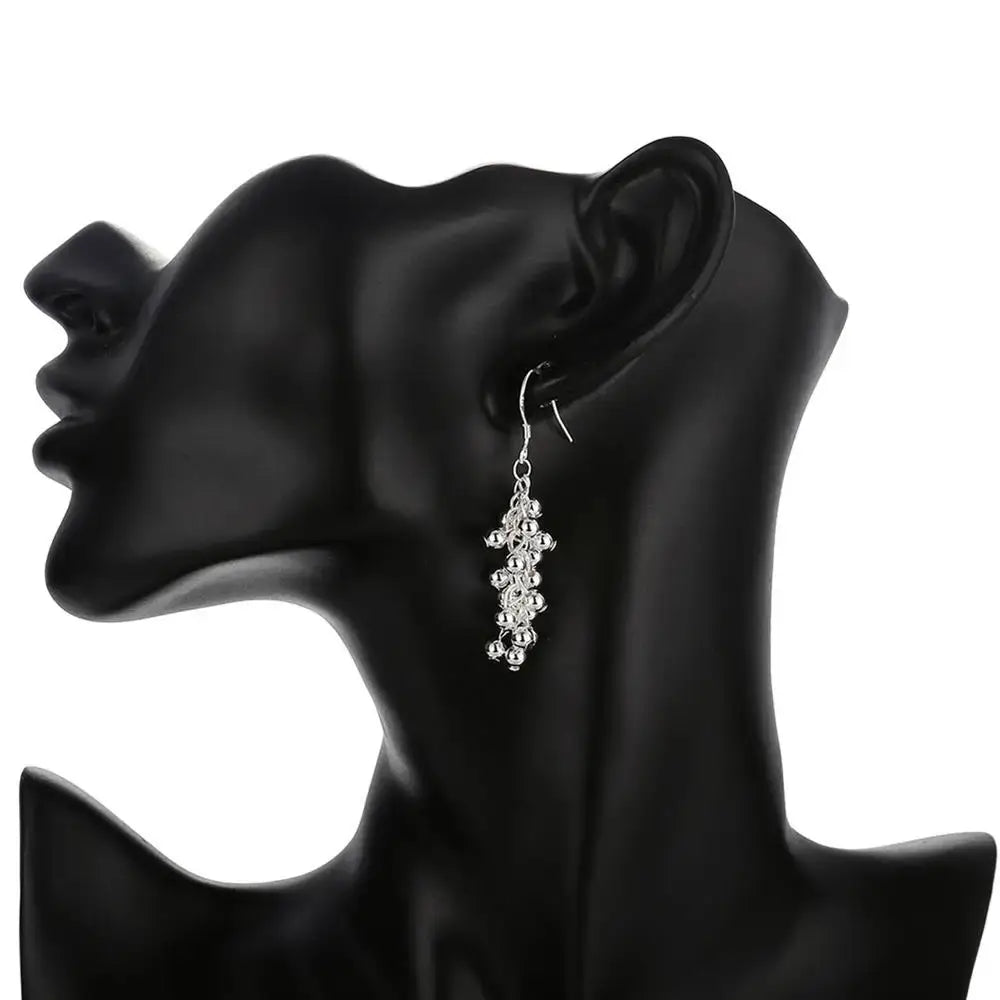 Silver dangling earring from 925 silver grape bead jewelry set featuring a cascading design of small round beads.