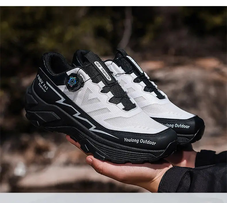 Men hiking shoes waterproof lightweight trekking sneakers in white and black with a mesh upper, rubber outsole, and circular lacing system.