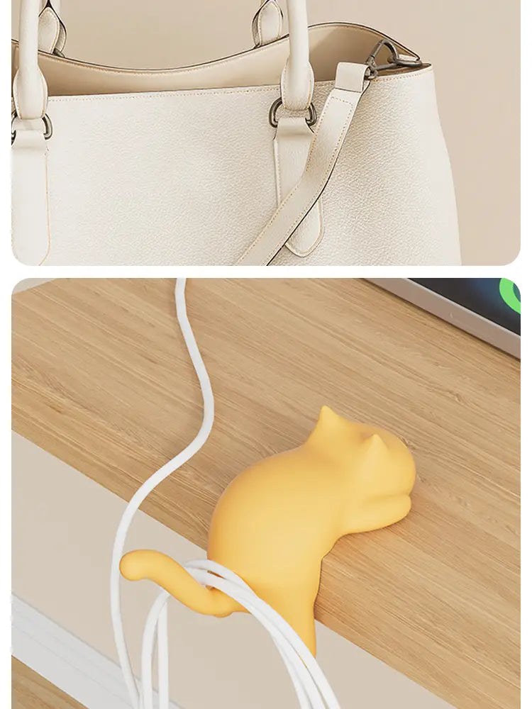 Yellow silicone cat-shaped cable organizer designed as a desk hook for managing cables efficiently.