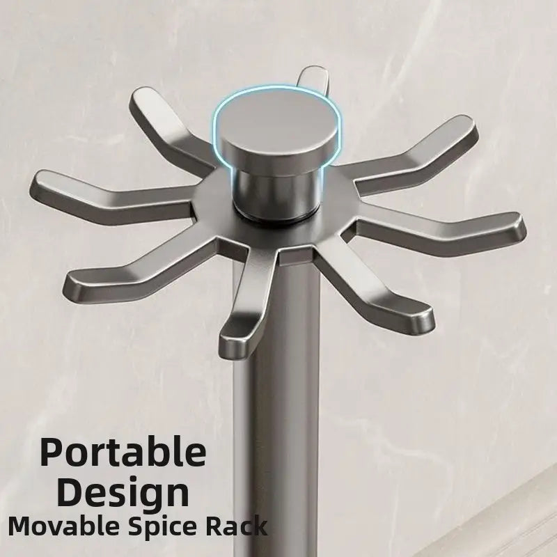 Silver metallic rotating kitchen utensil holder with starburst design, central cylindrical knob, and eight hooks for organized utensil storage.
