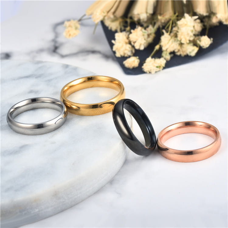 four sleek minimalist wedding bands in stainless steel with silver gold black and rose gold finishes featuring a 6mm rose gold stainless steel wedding band ring