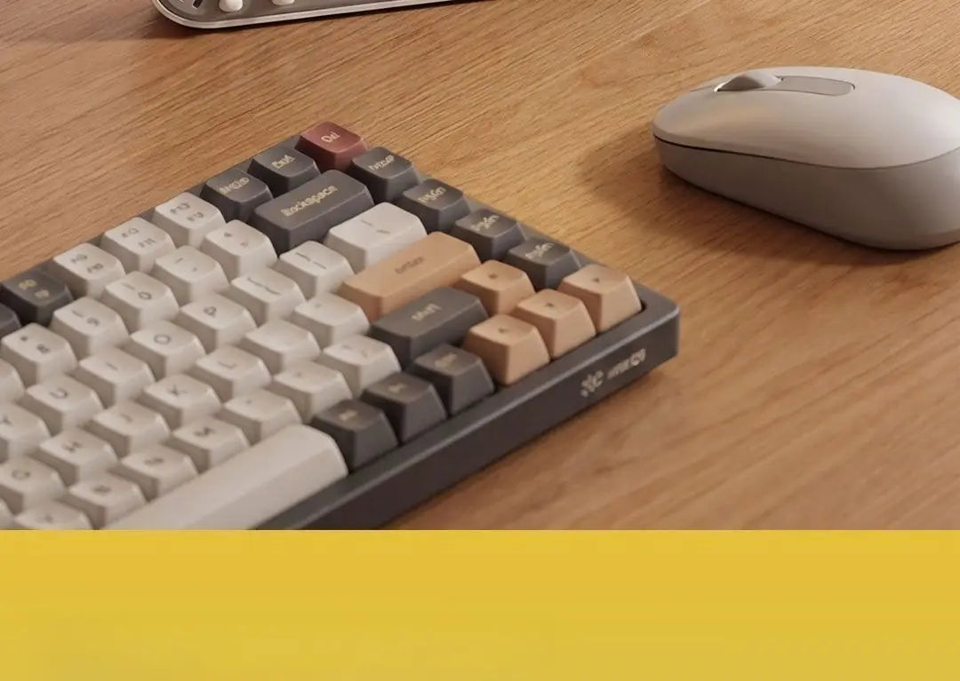 gray mechanical keyboard with beige and dark gray keycaps featuring a minimalist design displayed alongside the duka mooda smart temperature and humidity clock