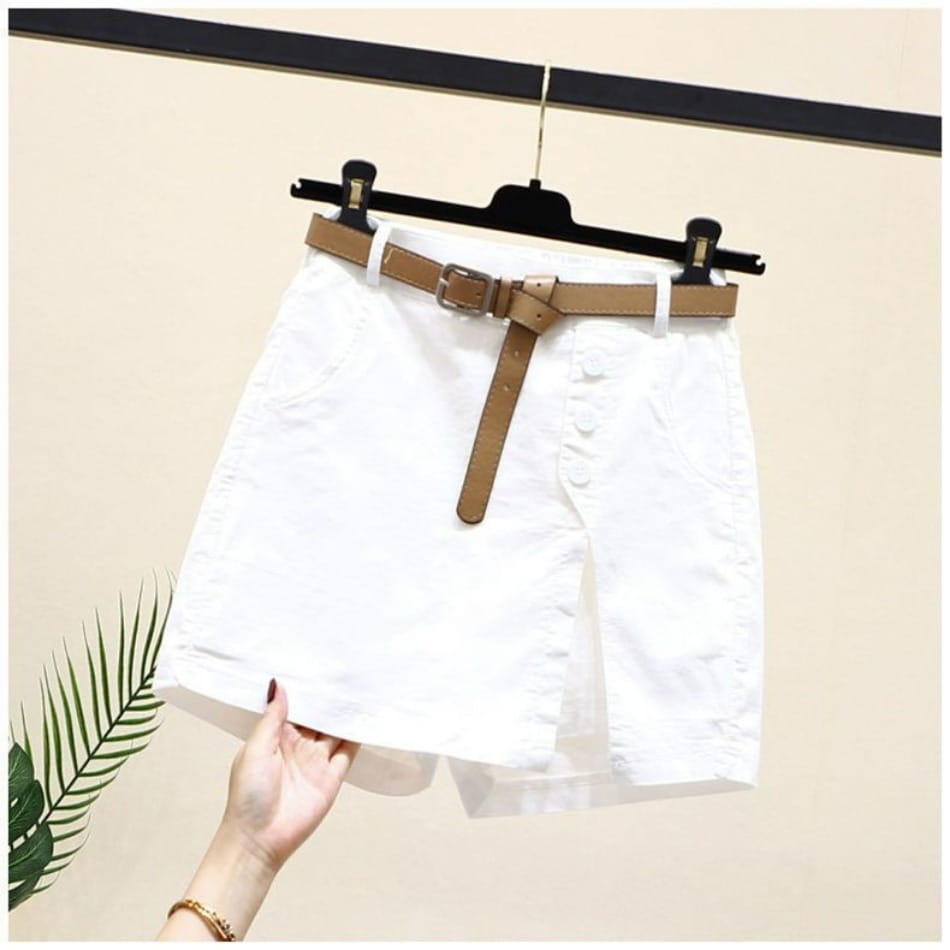 White denim office lady belted wide leg shorts with a tan leather belt and silver buckle.