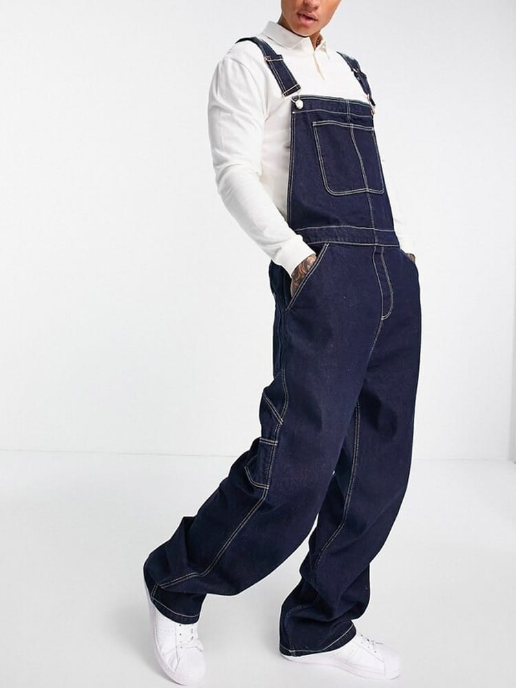 Dark blue denim overalls with contrasting white stitching and a classic relaxed fit designed for casual wear.